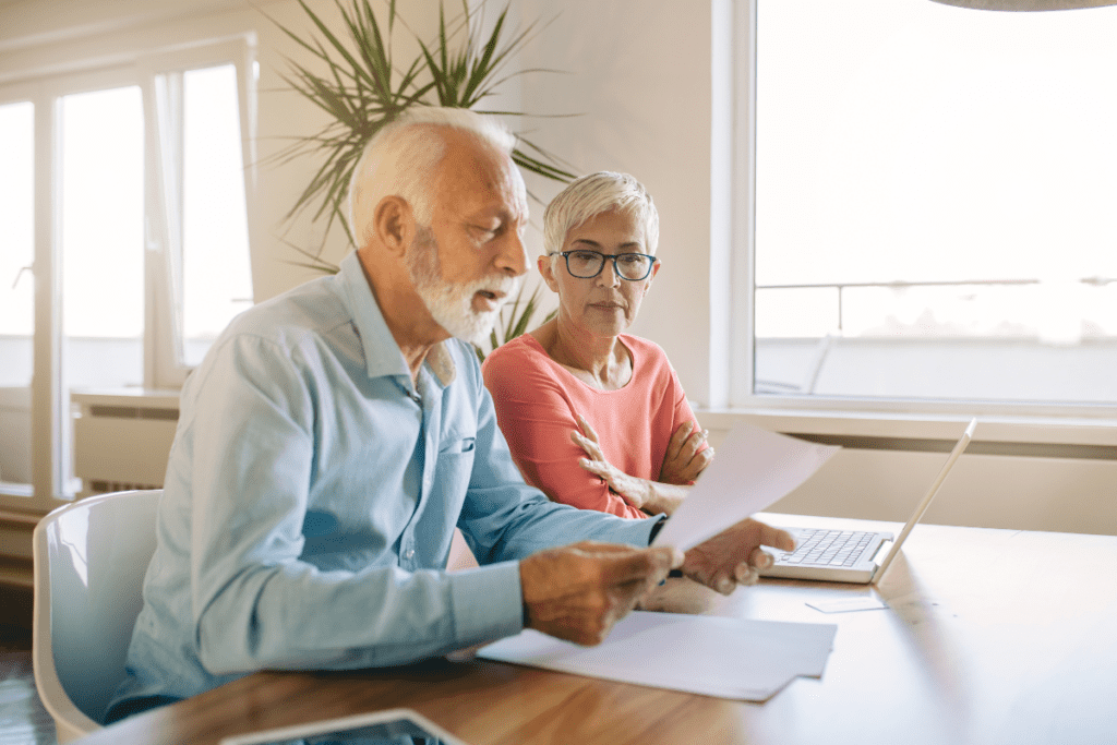 old couple looking at document